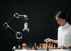 A woman plays chess against a robotic arm, showcasing AI innovation in a modern setting.